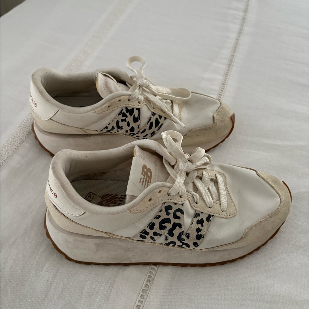 New Balance Off White and Black Sneakers with cheetah print.